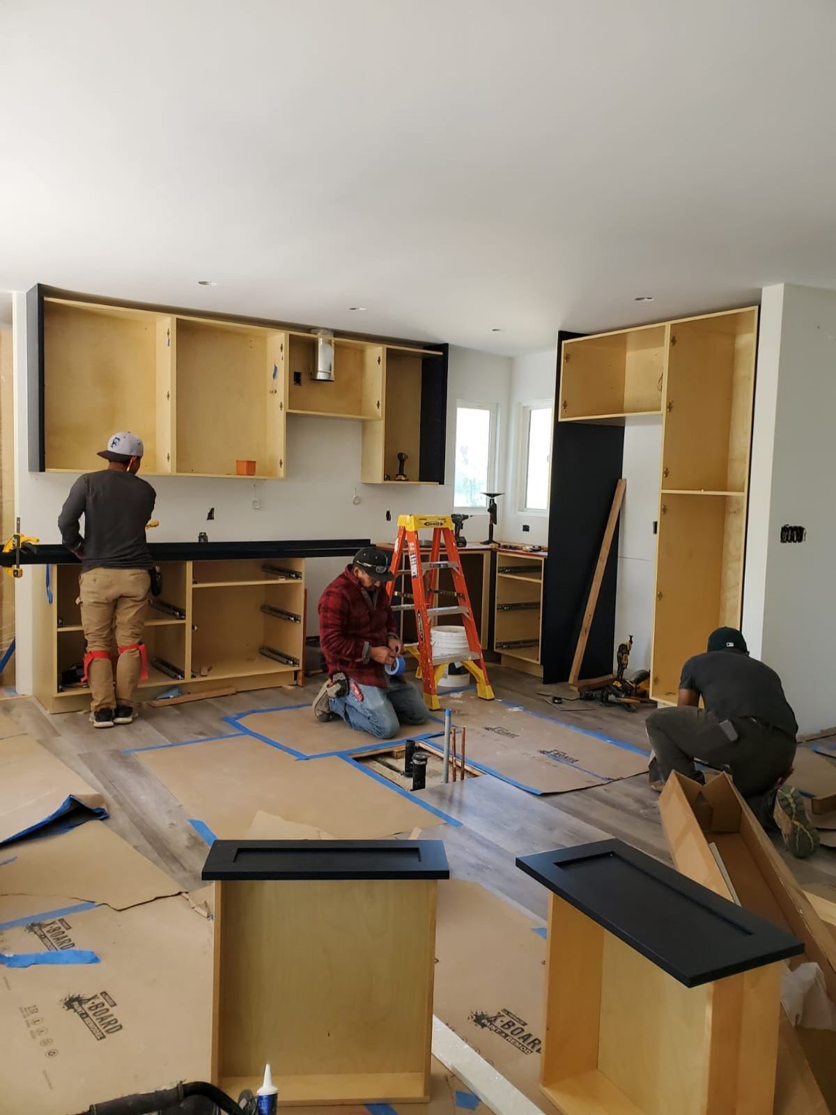 Our in-house crew installing custom cabinetry during a kitchen remodel
